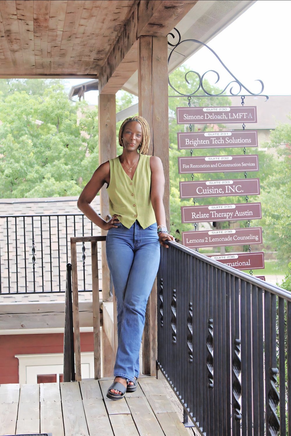 Simone Deloach outside her office, next to the suite sign reading Simone Deloach, LMFT-A