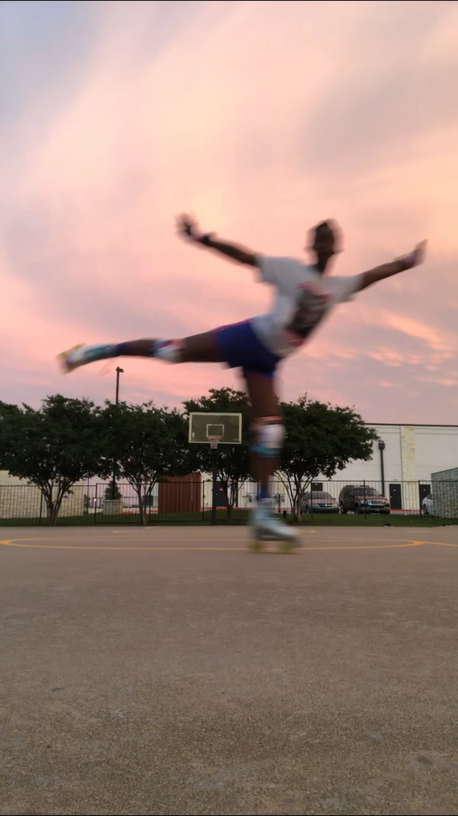 Simone roller skating on a basketball court at sunset